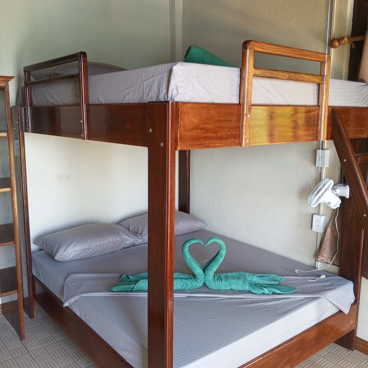 A bunk bed with two towels shaped like swans on it
