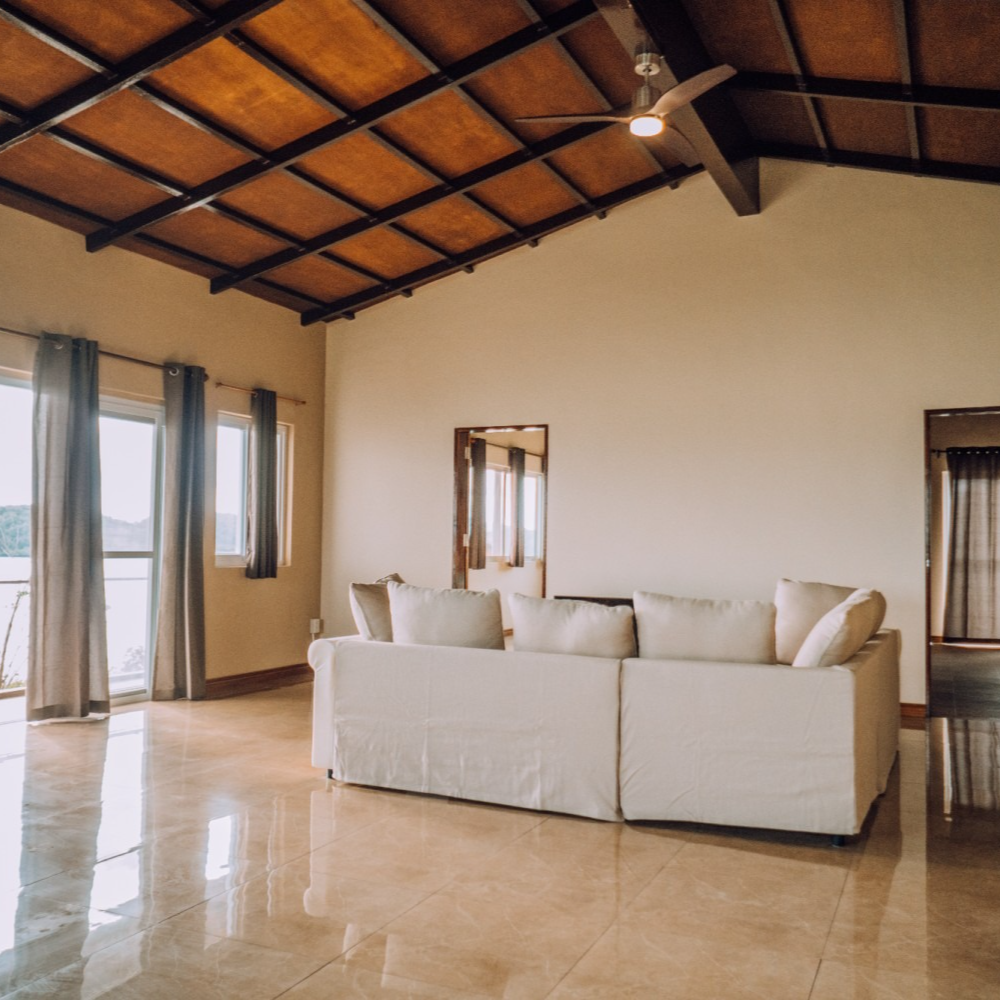 A living room with a ceiling fan and a couch