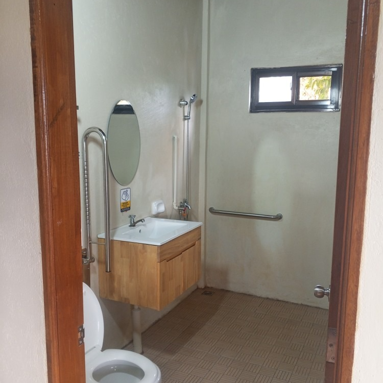 A bathroom with a toilet a sink and a mirror