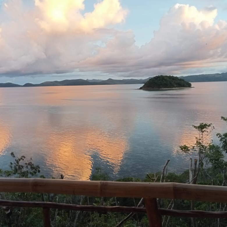 A small island in the middle of a large body of water