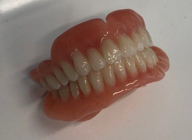 Dentures On A Table — Dentures And Mouthguards In Erina, NSW