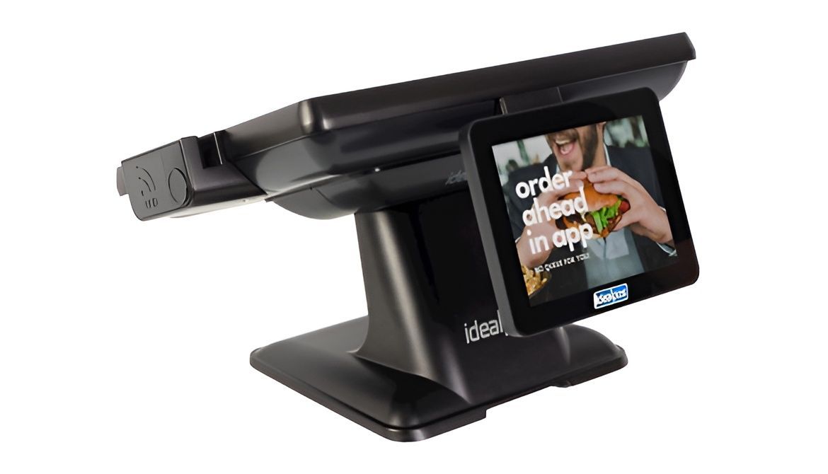A black point-of-sale (POS) touchscreen terminal, with a customer-facing screen displaying a burger ad — Coastal Registers & POS In Tweed Heads, NSW