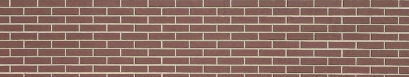 A close up of a brown brick wall with white tiles.