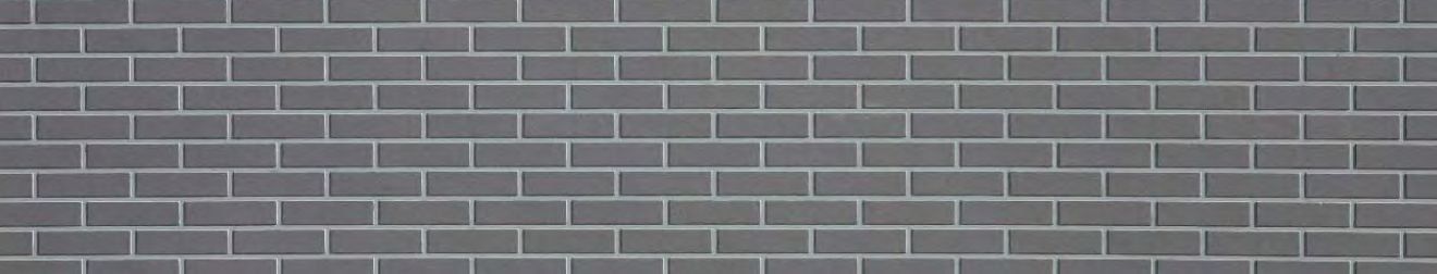 A close up of a gray brick wall.