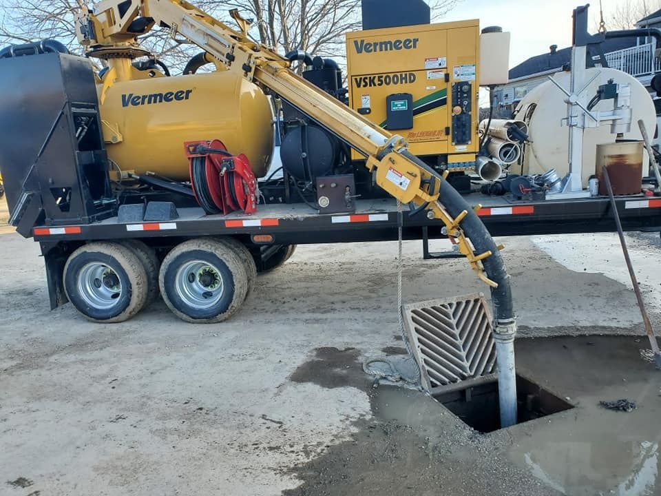 A yellow excavator is digging a tunnel in the dirt.