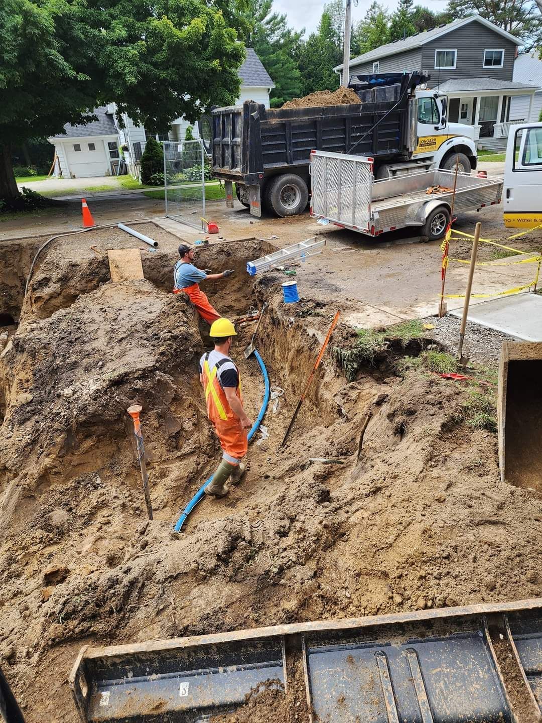 A group of construction workers are digging a hole in the ground.