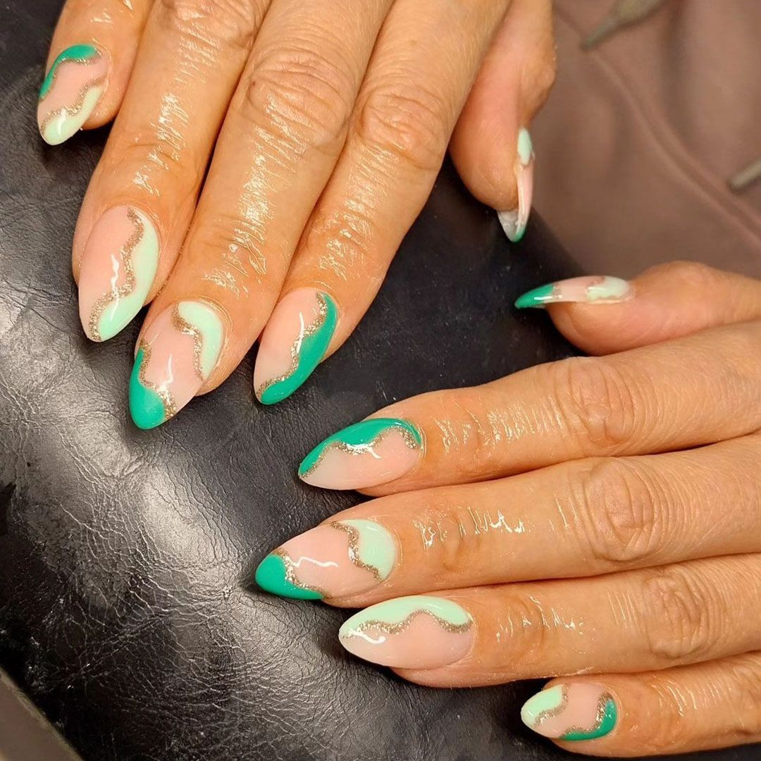 Hard gel extensions with green and gold swirls