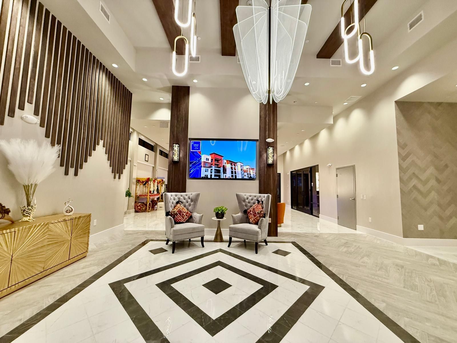 Family gathered outdoors laughing, embracing, with string lights overhead.