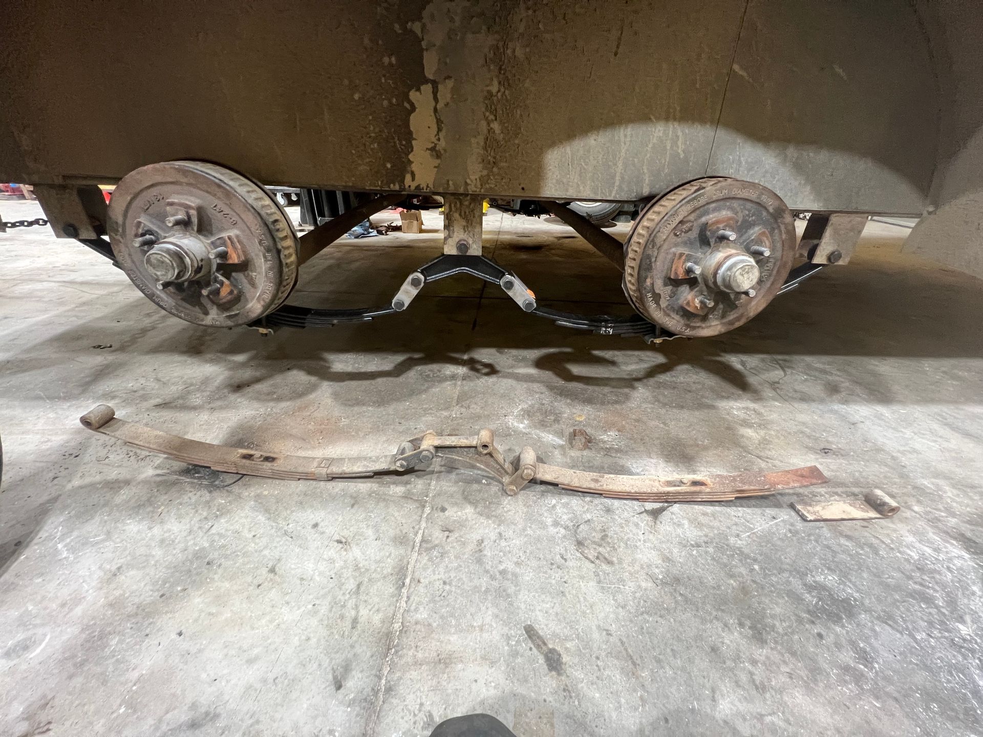 trailer with leaf springs on the concrete being repaired
