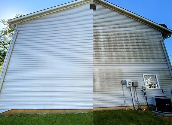 Side of a house, half cleaned with bright siding, other half dirty and stained.