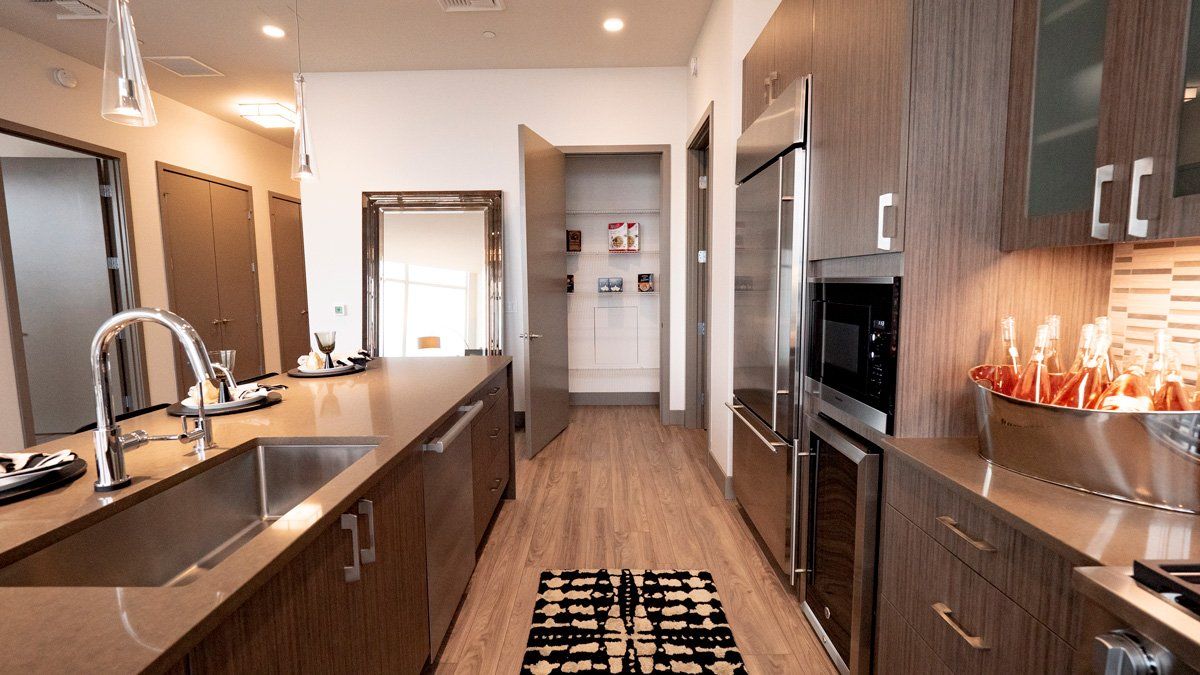 A kitchen with stainless steel appliances and wooden cabinets.