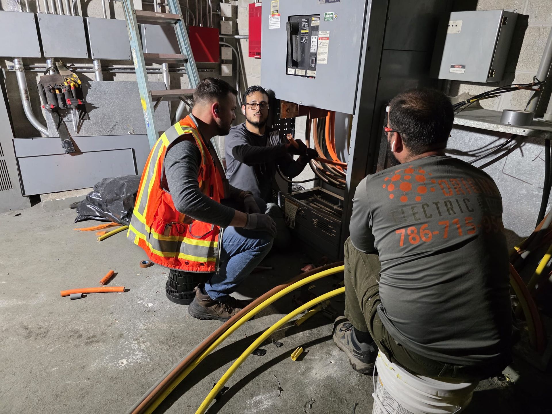 A gray electrical utility transformer mounted on a wooden utility pole against a sunset sky.