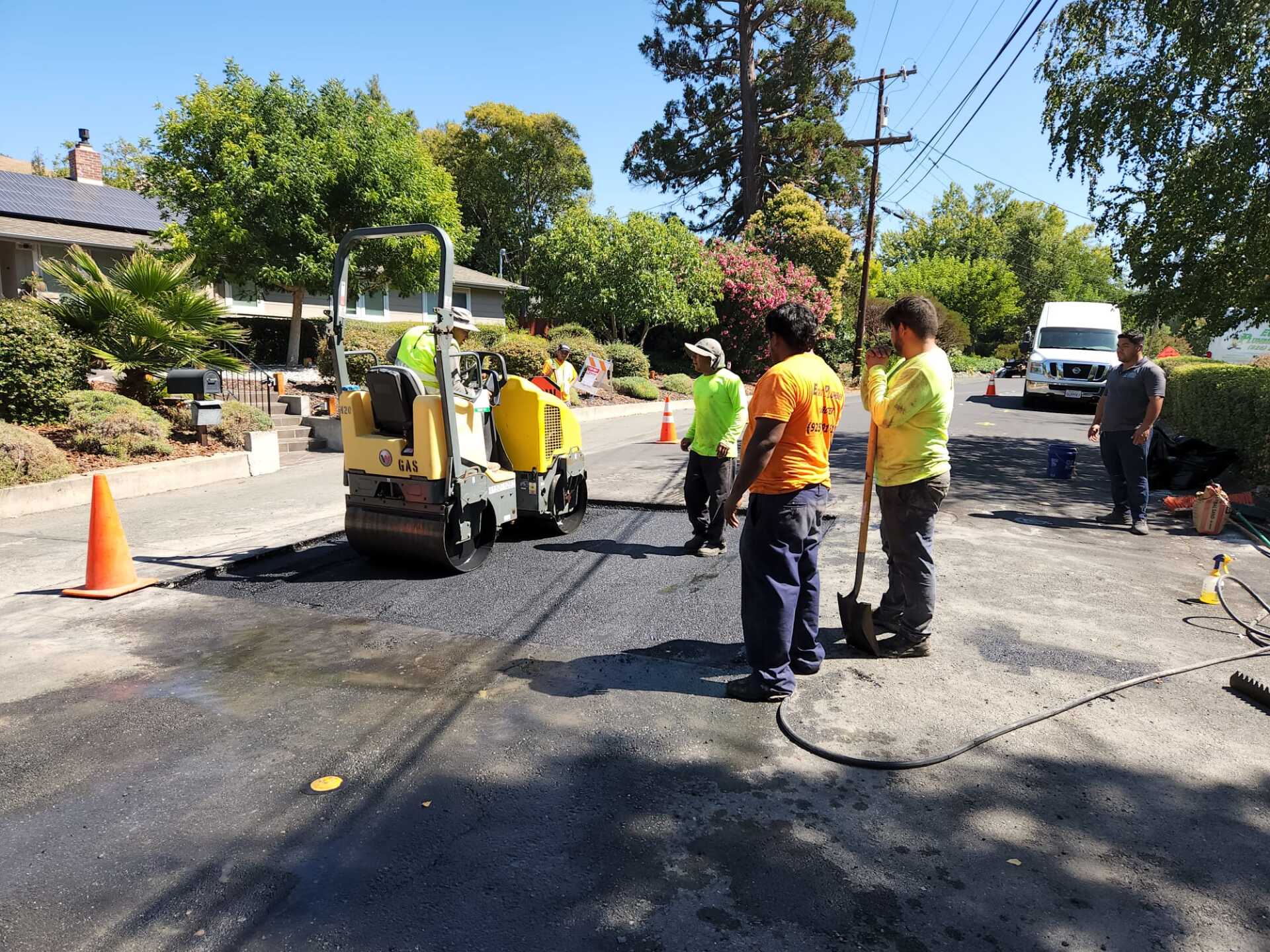 A group of construction workers are working on a road