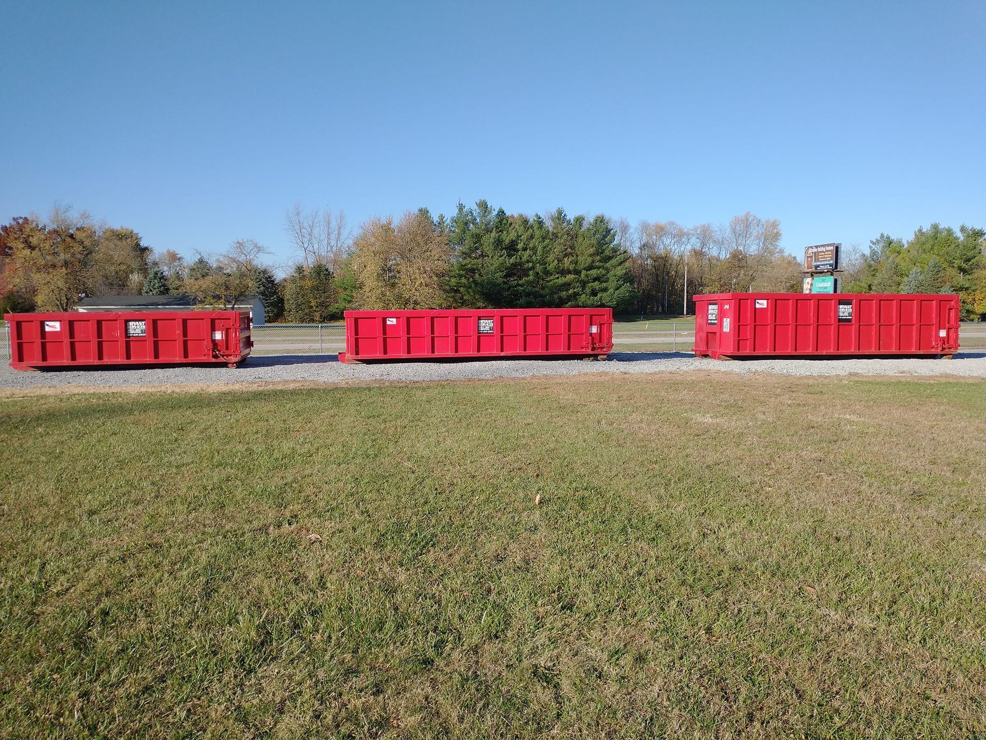 A blue dumpster on a wooden pallet | Roll Off Dumpster Rentals | Bryant Industries