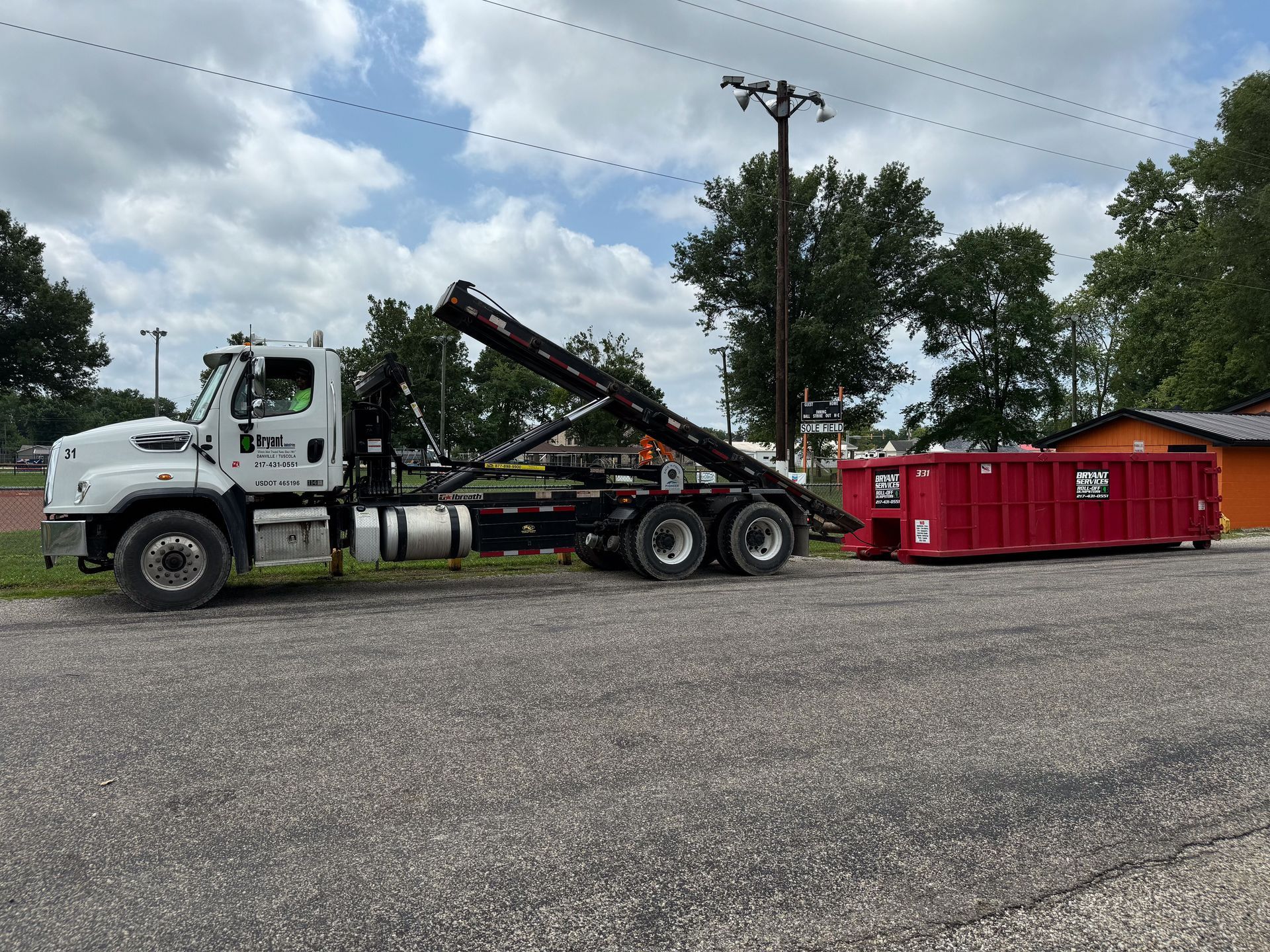 open red metal industrial waste container