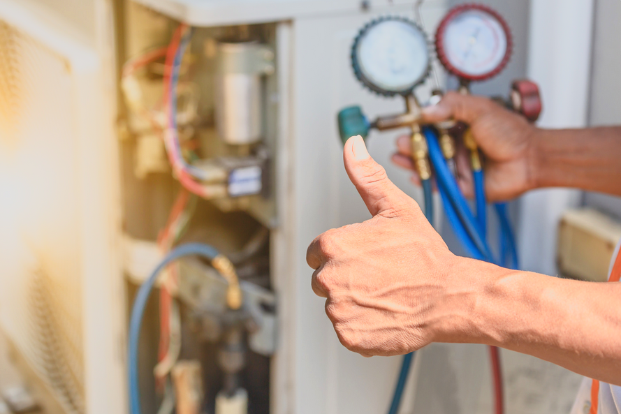A man is working on an electrical outlet on a wall