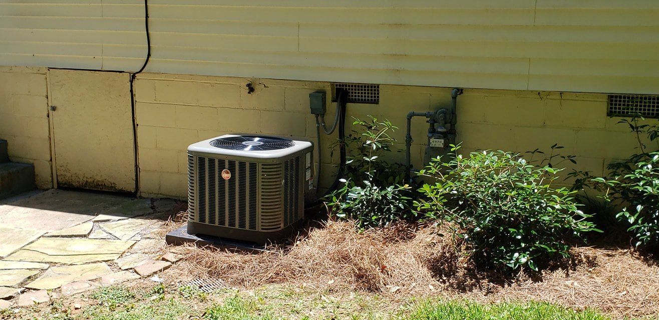 An air conditioner is sitting on the side of a house