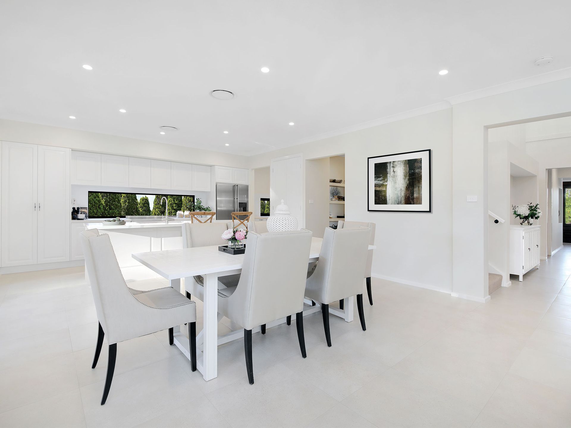 Zen 45 home design of a dining room with a table and chairs in a white house.