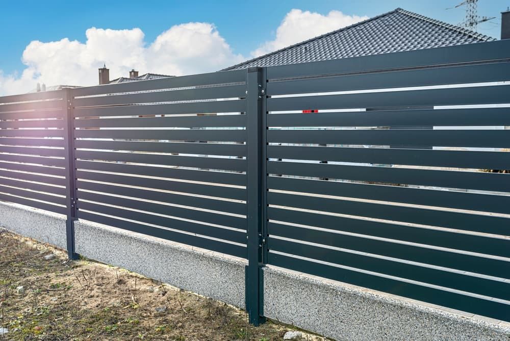 A Black Fence Is Surrounding a House in A Residential Area — DW Fencing Tamworth in Taminda, NSW