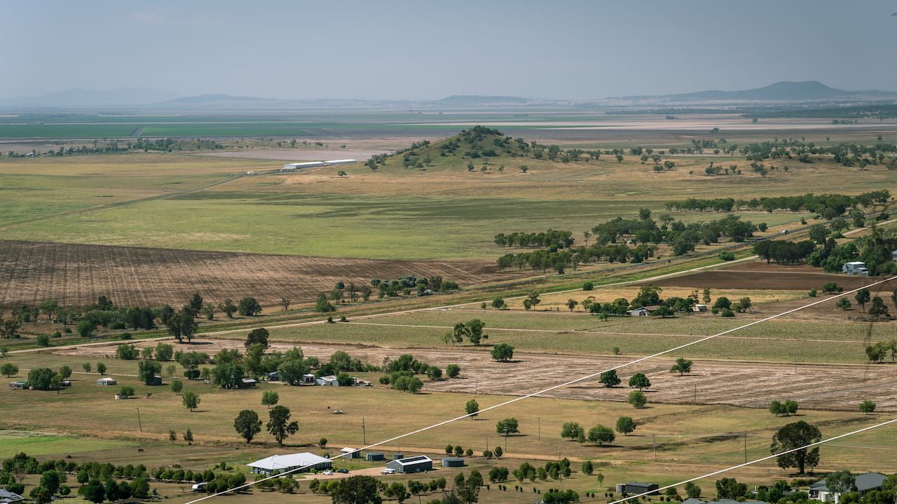 An Aerial View of A Lush Green Field with Trees and A Lake in The Background — DW Fencing Tamworth in Gunnedah, NSW