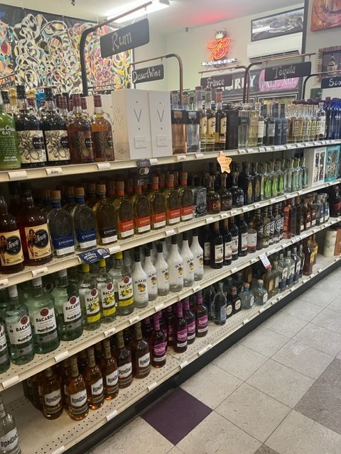 A liquor store with a sign that says rum on it