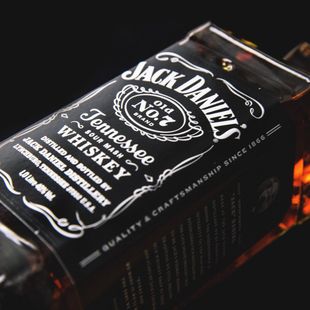 a bottle of jack daniel 's tennessee whiskey on a black background