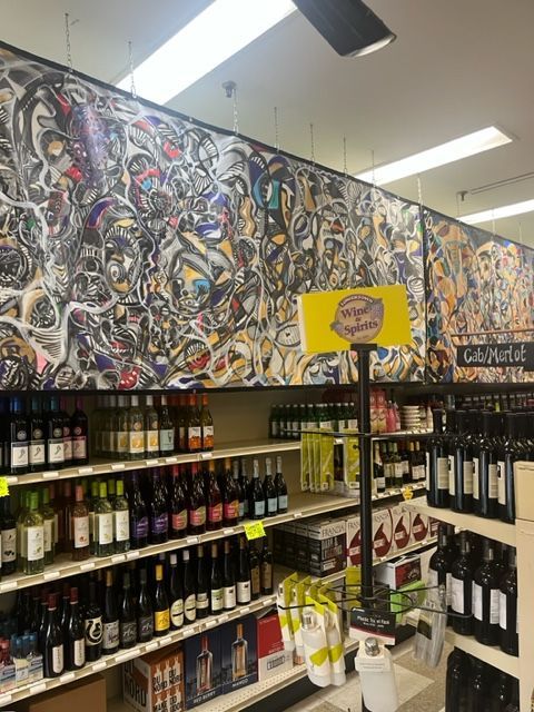 A grocery store aisle with a sign that says go wild