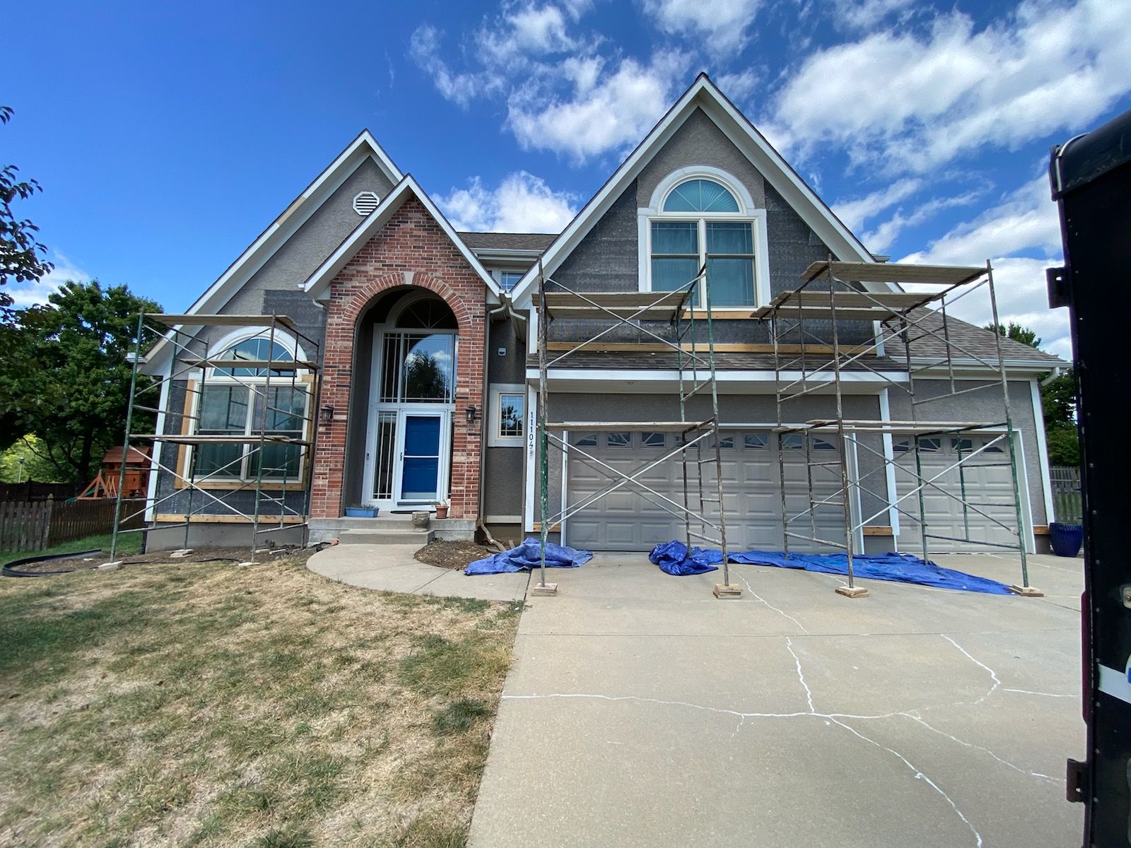 A house is being painted with scaffolding in front of it.