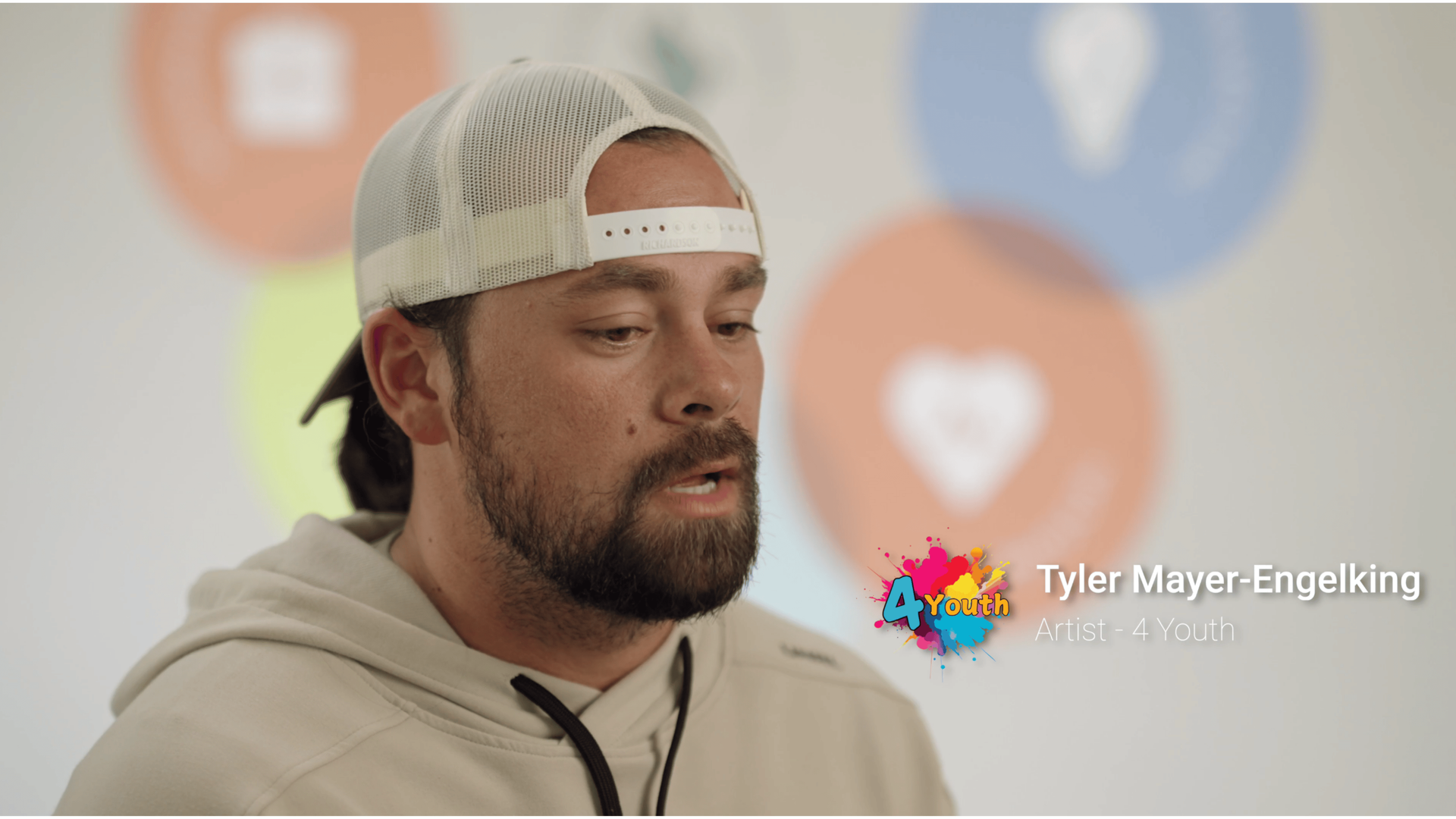 Two women laughing while painting in an art studio.
