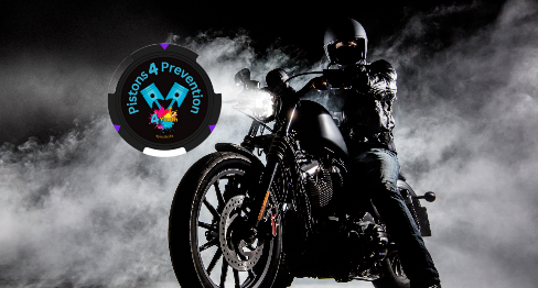 Motorcyclist on black bike amid smoky backdrop, logo 