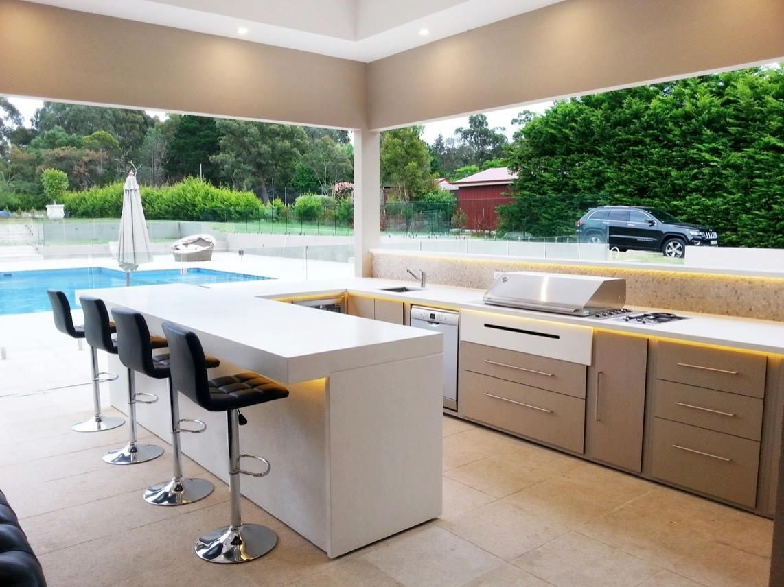 A Kitchen with A Large Island and Stools Next to A Swimming Pool — Thats Tops by Design in Quirindi, NSW