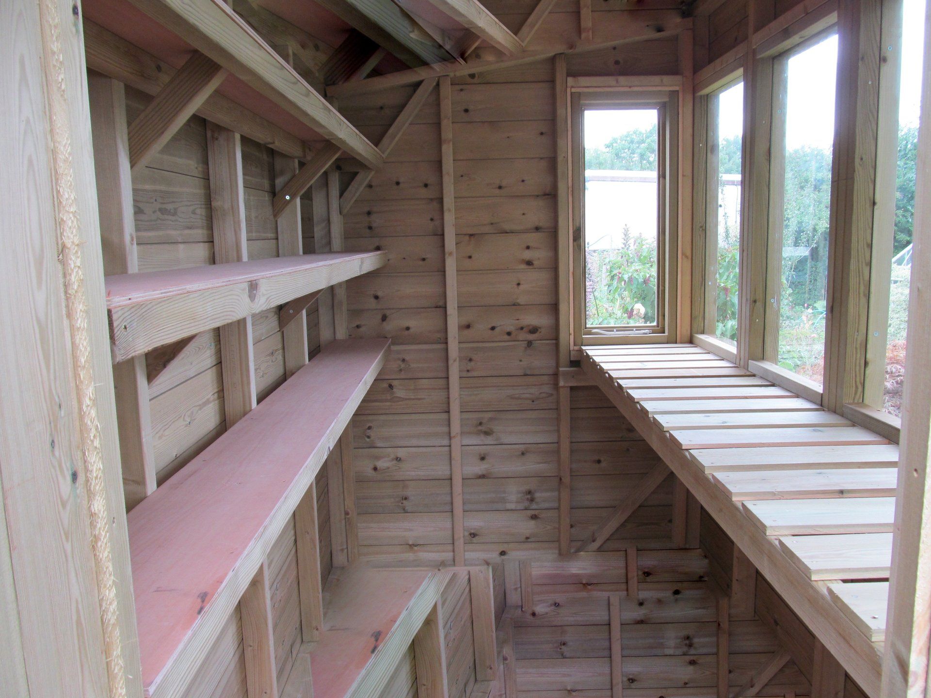 Potting Shed shelving inside gardner's light flooded double glazed potting shed