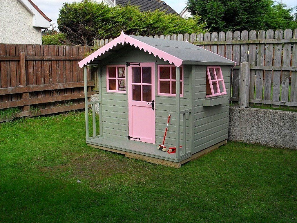 Painted playhouse with felted roof and pink painted doors and windows