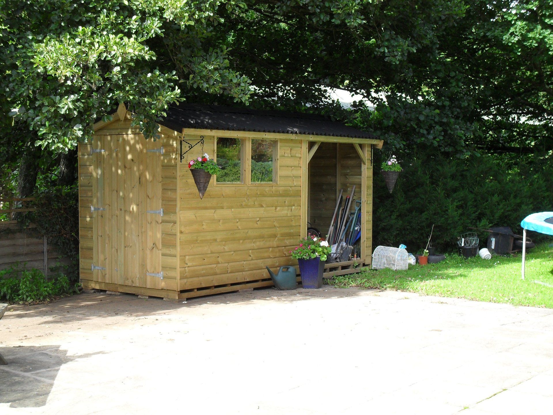 Workshop shed with outside storage area double windows to the side and door to the front