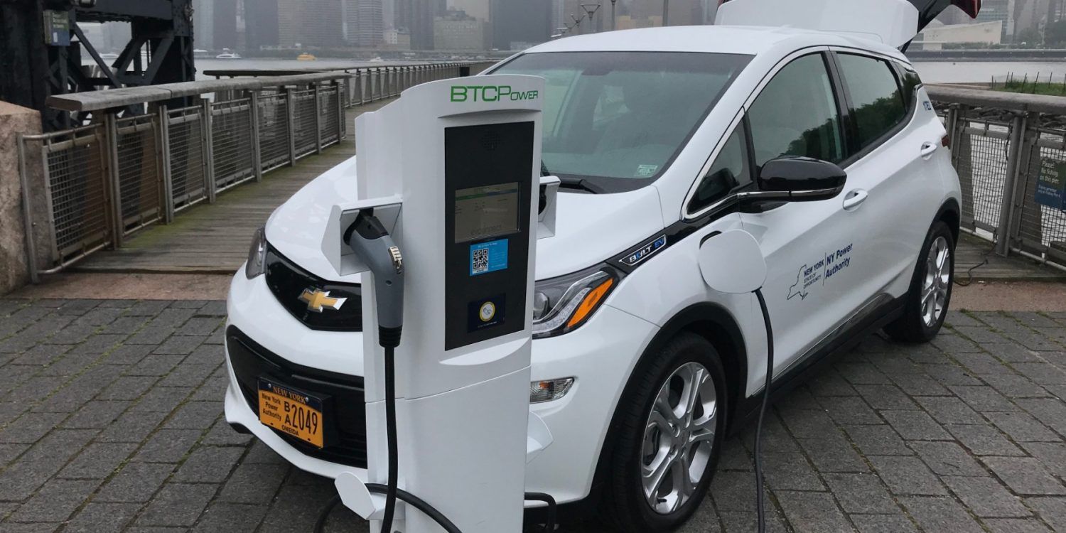 White Chevy Bolt at BTC Power Charging Station - Photo