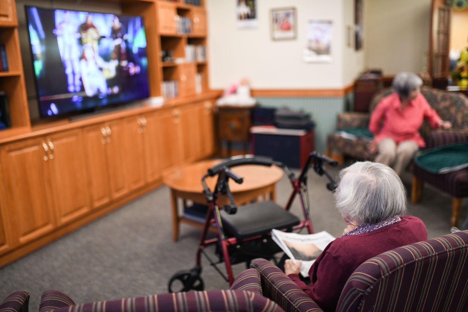 Residents enjoying group activities and watching television at Watson Assisted Living