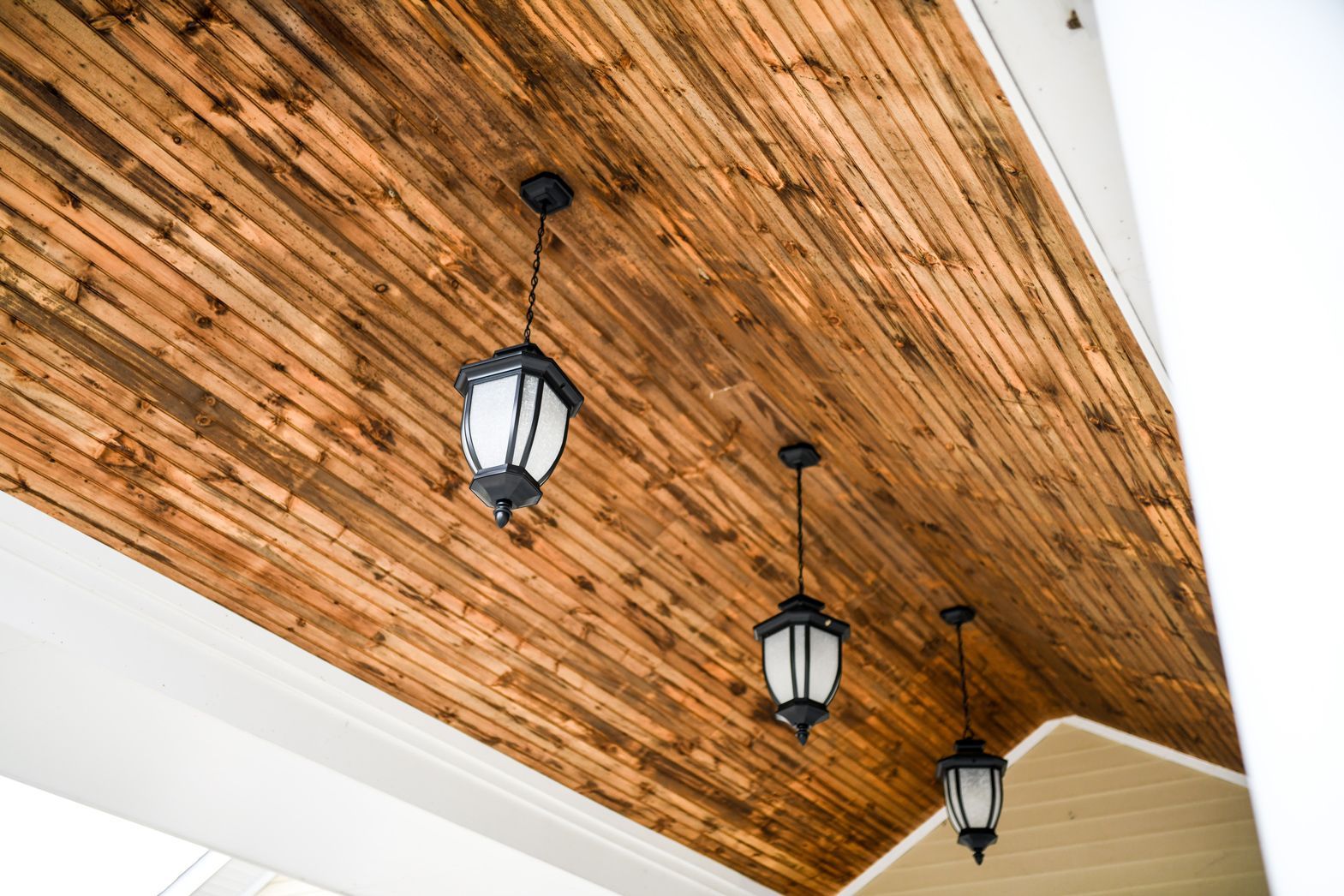 Wooden ceiling with decorative hanging lights in Watson Assisted Living common area
