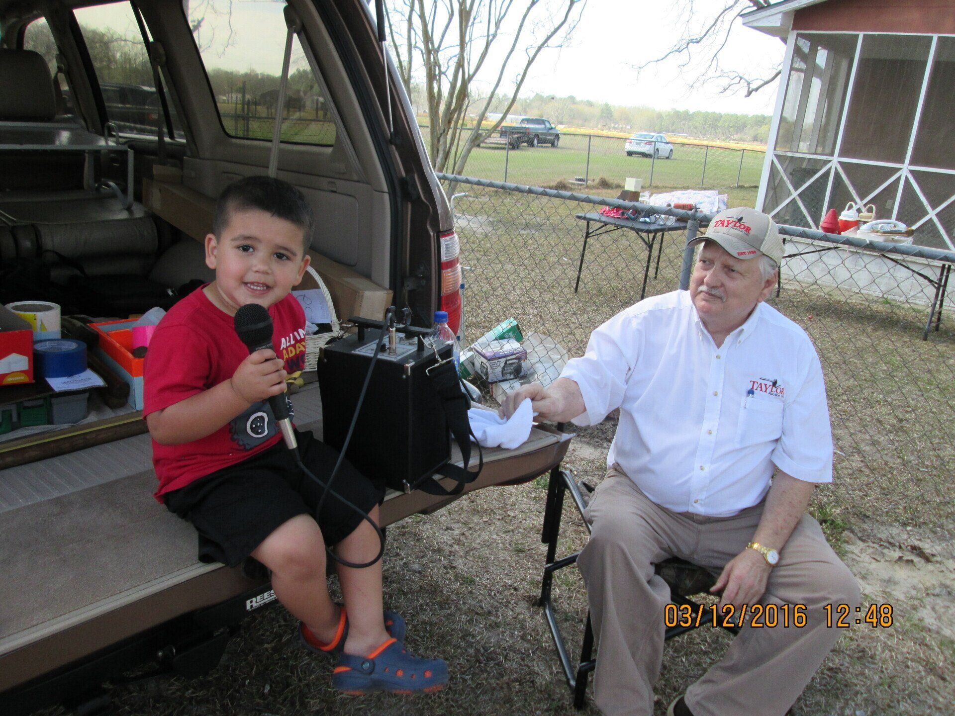 Kid Holding Microphone - Marion, IL - Taylor Auction and Realty
