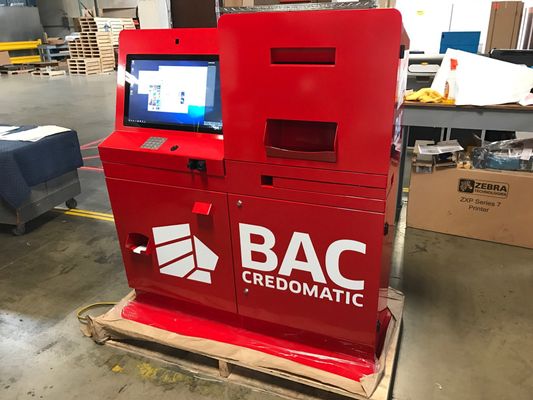 Large red custom built payment kiosk for BAC Credomatic  in factory getting ready to be shipped