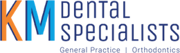 A blue and white logo for km dental specialists