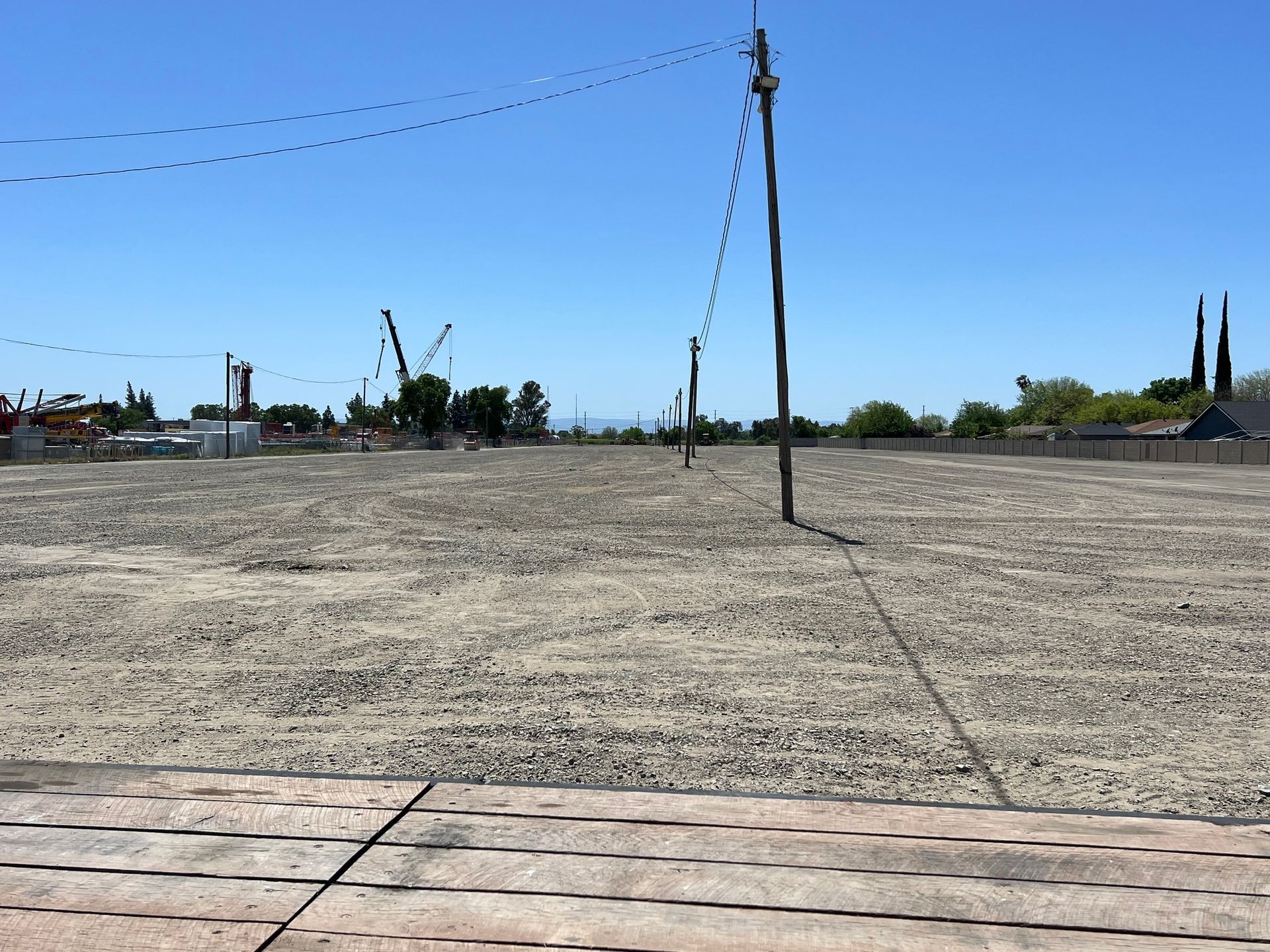 An empty field with a barbed wire fence in the background