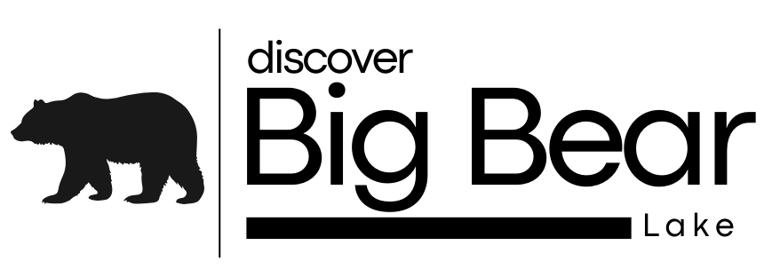 Bear wearing goggles and carrying a snowboard; Discover Big Bear Lake logo.