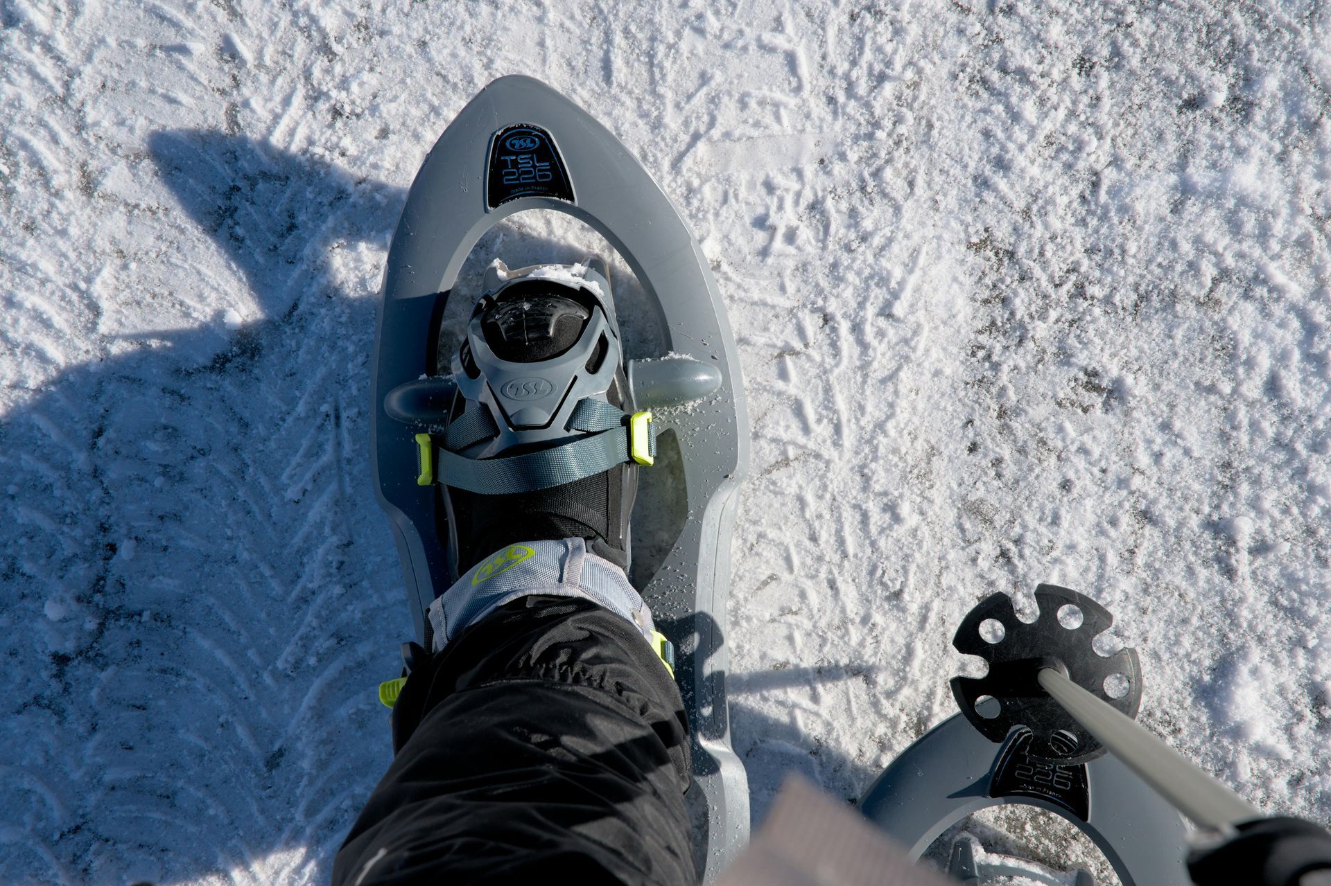 Person wearing snowshoes on snow.
