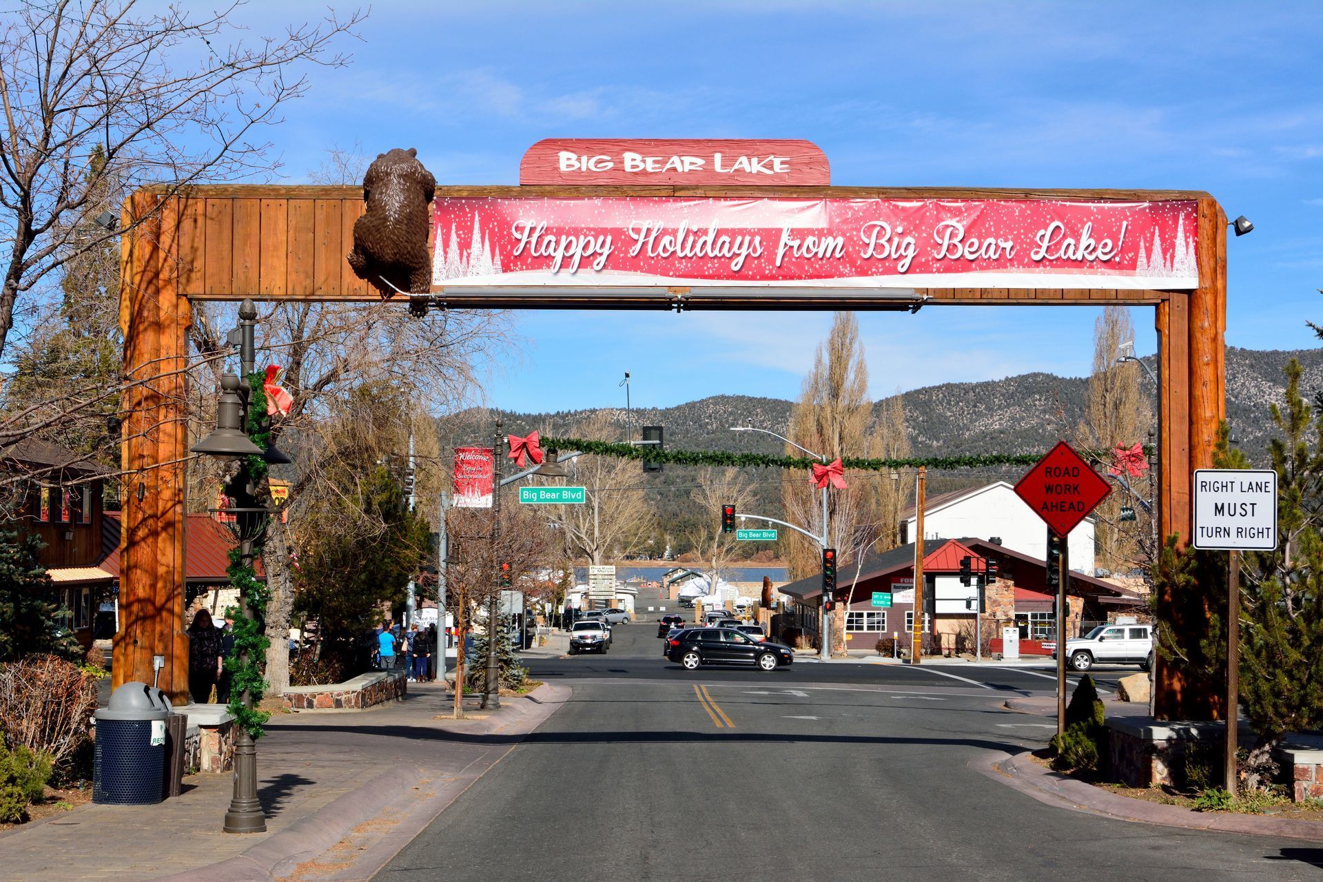 a wooden archway says happy holidays from big bear lake located in the village in Big Bear Lake
