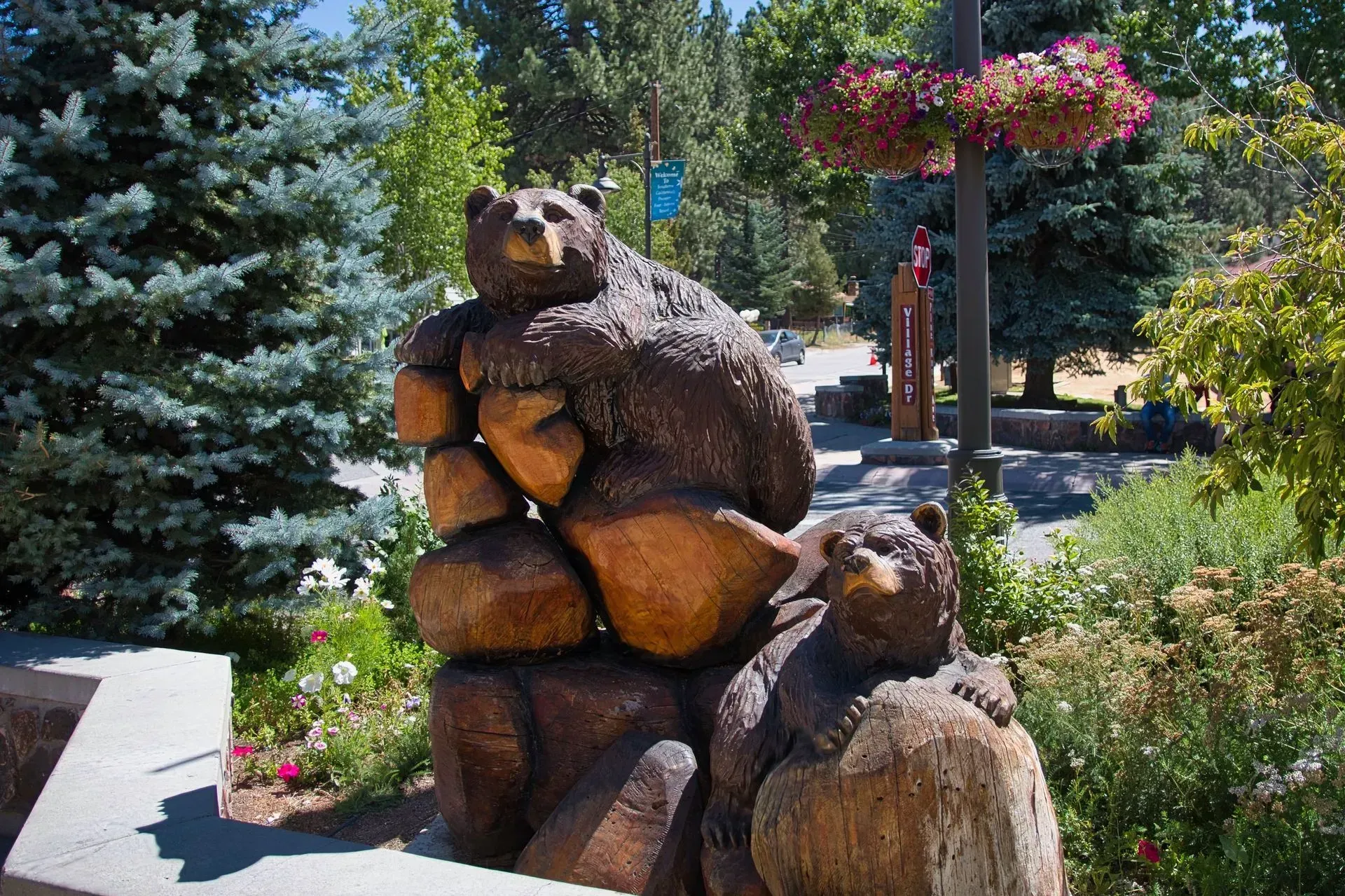 A statue of three bears sitting on rocks in the Village in Big Bear Lake