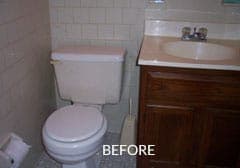 A bathroom with a toilet , sink and vanity.