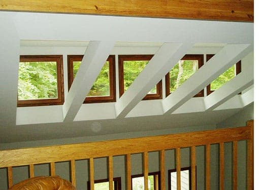 Top of wall with five windows and a wooden rbeams