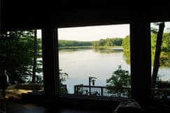 A view of a river through a window in a house.