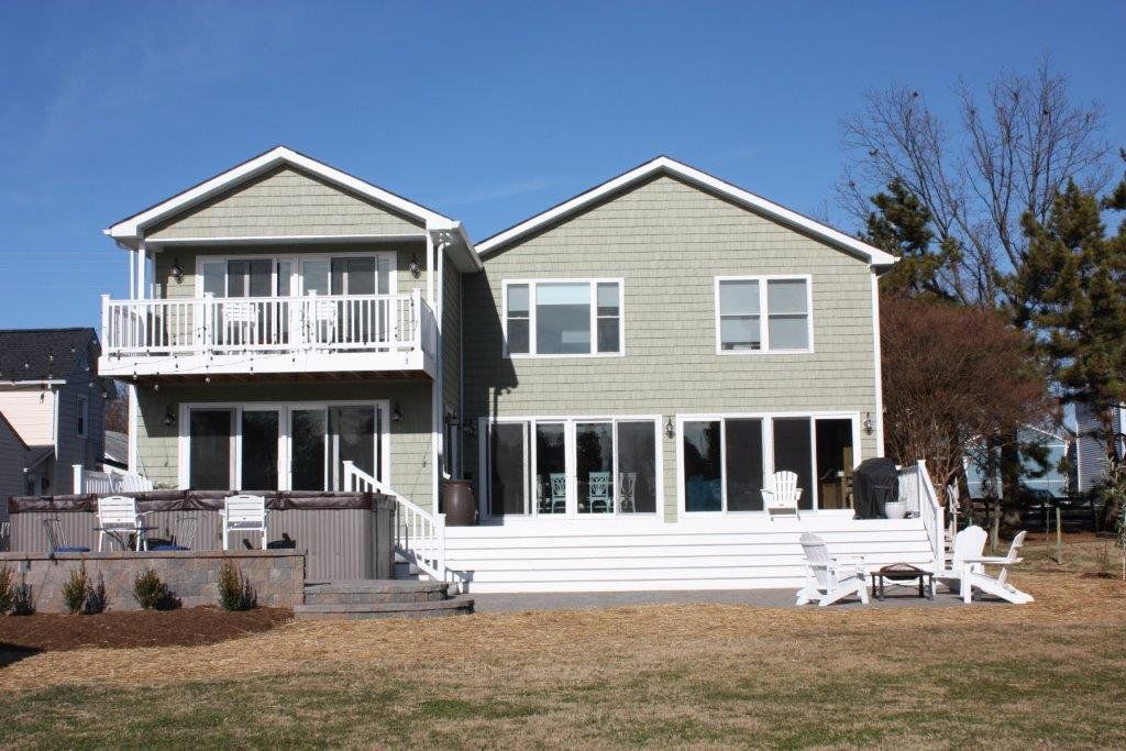 A large 2-story house with a lot of windows and doors.  