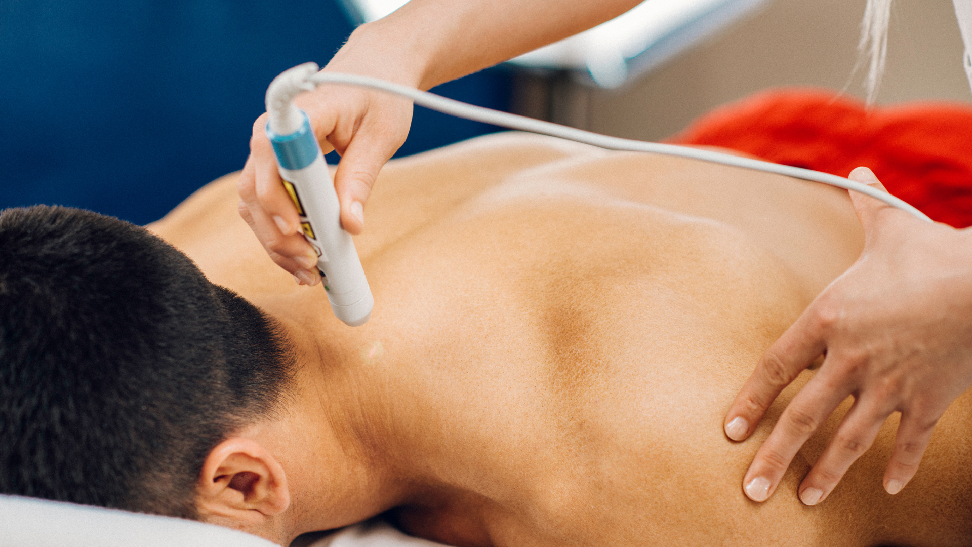 A man is getting a laser treatment on his back.
